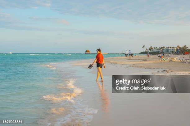 woman   walking on the  of seaside on  isla mujeres - mayan riviera stock pictures, royalty-free photos & images