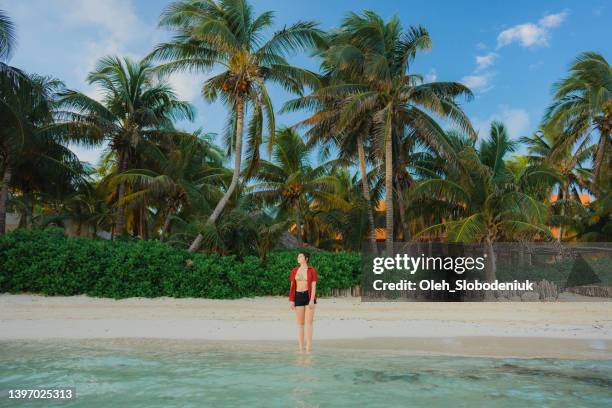 femme marchant sur le bord de mer sur isla mujeres - playa del carmen photos et images de collection