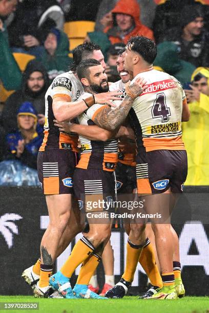 Corey Oates of the Broncos is congratulated by team mates after scoring a try during the round 10 NRL match between the Manly Sea Eagles and the...