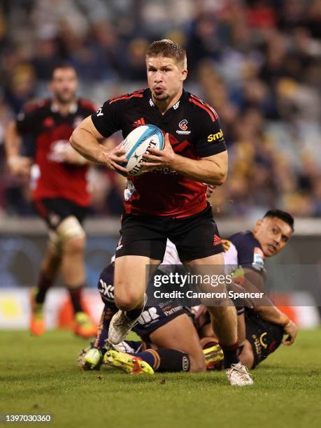 Jack Goodhue of the Crusaders makes a break during the round 13 Super Rugby Pacific match between the ACT Brumbies and the Crusaders at GIO Stadium...