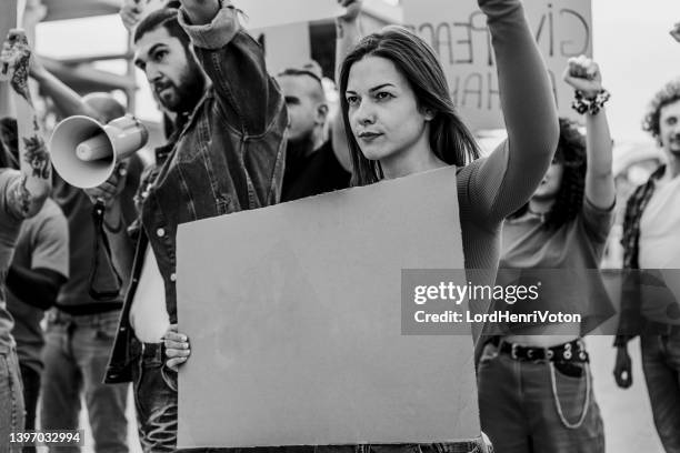 frau während einer demonstration auf der straße - anti regierungsdemonstration stock-fotos und bilder