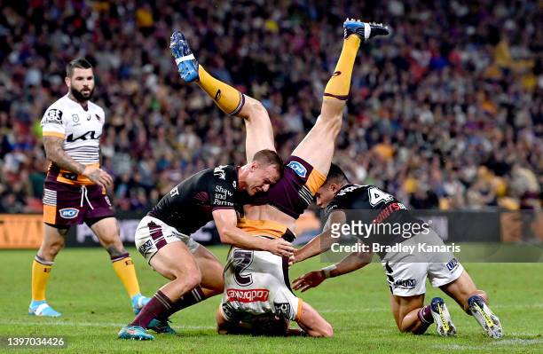 Corey Oates of the Broncos is upended in the tackle during the round 10 NRL match between the Manly Sea Eagles and the Brisbane Broncos at Suncorp...