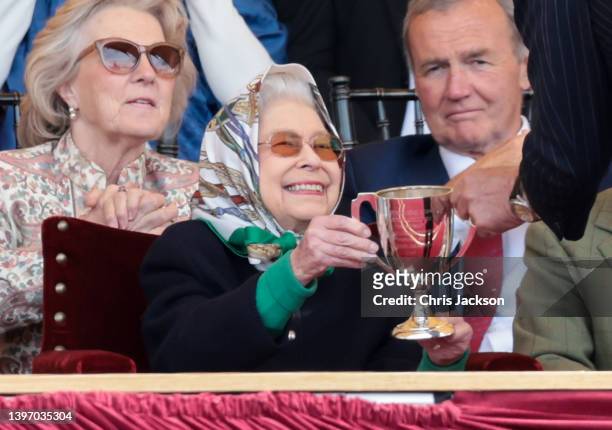 Queen Elizabeth II receives the winners cup at The Royal Windsor Horse Show at Home Park on May 13, 2022 in Windsor, England. The Royal Windsor Horse...