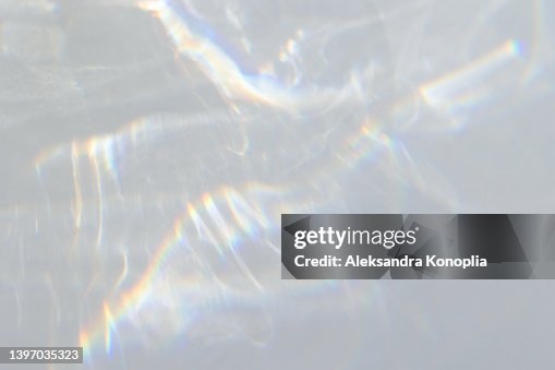 Blurred dreamy surreal rainbow light refraction texture overlay effect on white wall Blurred dreamy surreal rainbow light refraction texture overlay effect on white wall