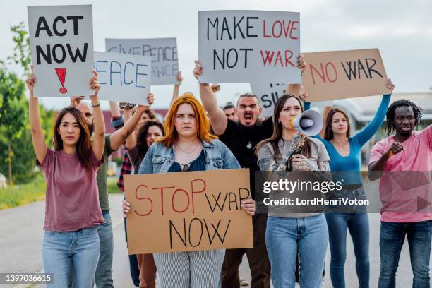 anti-war protest in the city street - aapi protest stock pictures, royalty-free photos & images