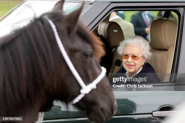 Queen Elizabeth II watches the horses from her Range Rover at The Royal Windsor Horse Show at Home Park on May 13, 2022 in Windsor, England. The...