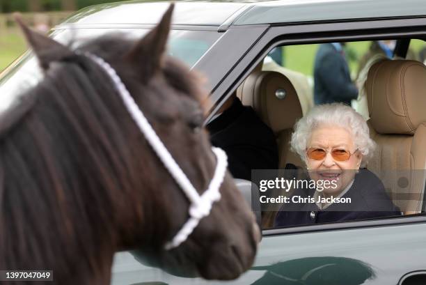 Queen Elizabeth II watches the horses from her Range Rover at The Royal Windsor Horse Show at Home Park on May 13, 2022 in Windsor, England. The...