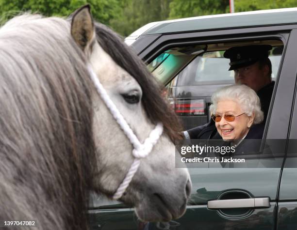 Queen Elizabeth II watches the horses from her Range Rover at The Royal Windsor Horse Show at Home Park on May 13, 2022 in Windsor, England. The...