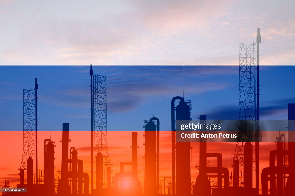 Oil refinery plant of petroleum on the background of of the russian flag