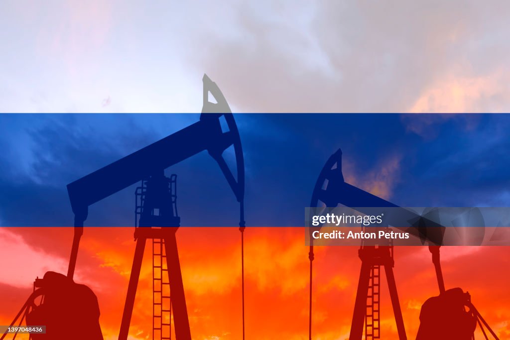 Oil pump on the background of of the russian flag