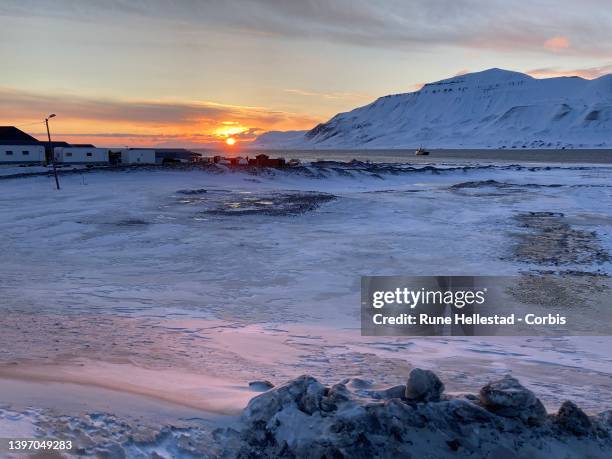 Scenic view with the midnight sun in Longyearbyen on April 21, 2022 in Svalbard, Norway.