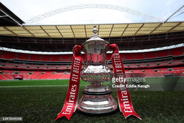 The FA Cup trophy is photographed by the pitch on the eve of The FA Cup Final match between Chelsea and Liverpool at Wembley Stadium on May 13, 2022...