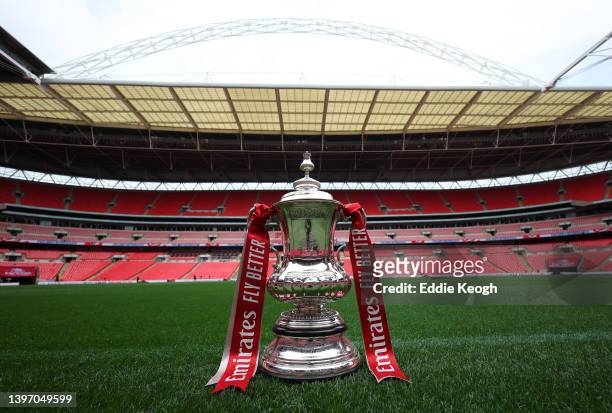 The FA Cup trophy is photographed by the pitch on the eve of The FA Cup Final match between Chelsea and Liverpool at Wembley Stadium on May 13, 2022...