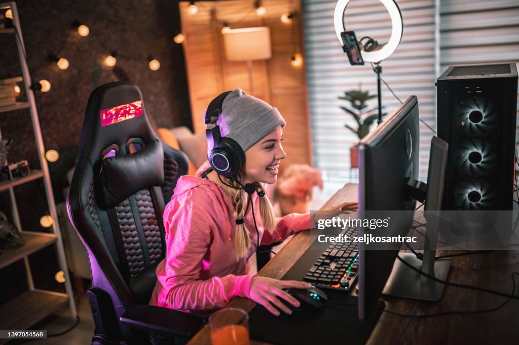 Girl plays video game online and streaming at home