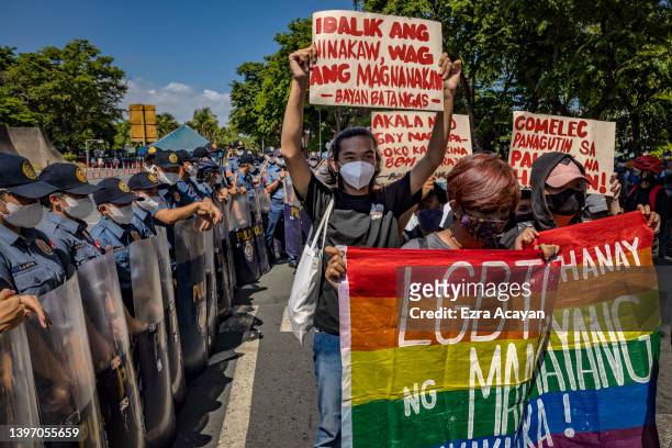 Filipinos take part in a protest against election results outside the Philippine International Convention Center, where votes are being canvassed, on...
