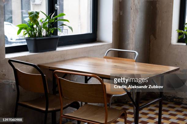 tables and chairs in an empty cafe, office, coworking or room. stylish design, vintage style. closed restaurant, isolation due to covid and coronavirus. a place for breakfast and meetings, a kitchen. there are no visitors due to the global crisis. - dining table stock pictures, royalty-free photos & images