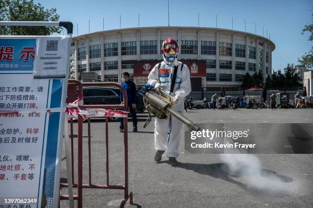 Firefighter disinfects the area at a nucleic acid testing site to detect COVID-19 on May 13, 2022 in Beijing, China. China is trying to contain a...