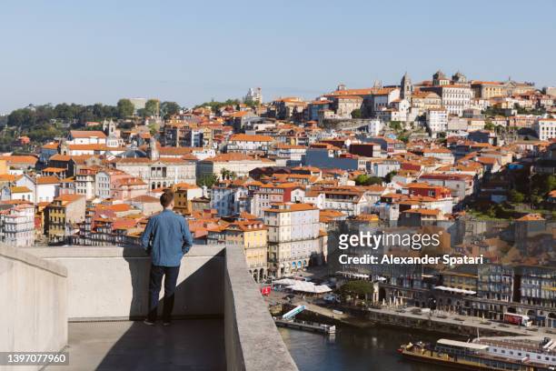 rear view of a man looking at porto cityscape from above - portuguese culture fotografías e imágenes de stock