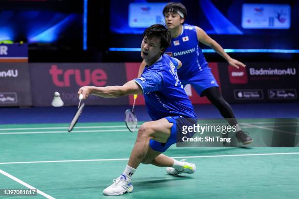 Akira Koga and Yuta Watanabe of Japan compete in the Thomas Cup Semi Final Men's Double match against Fajar Alfian and Muhammad Rian Ardianto of...