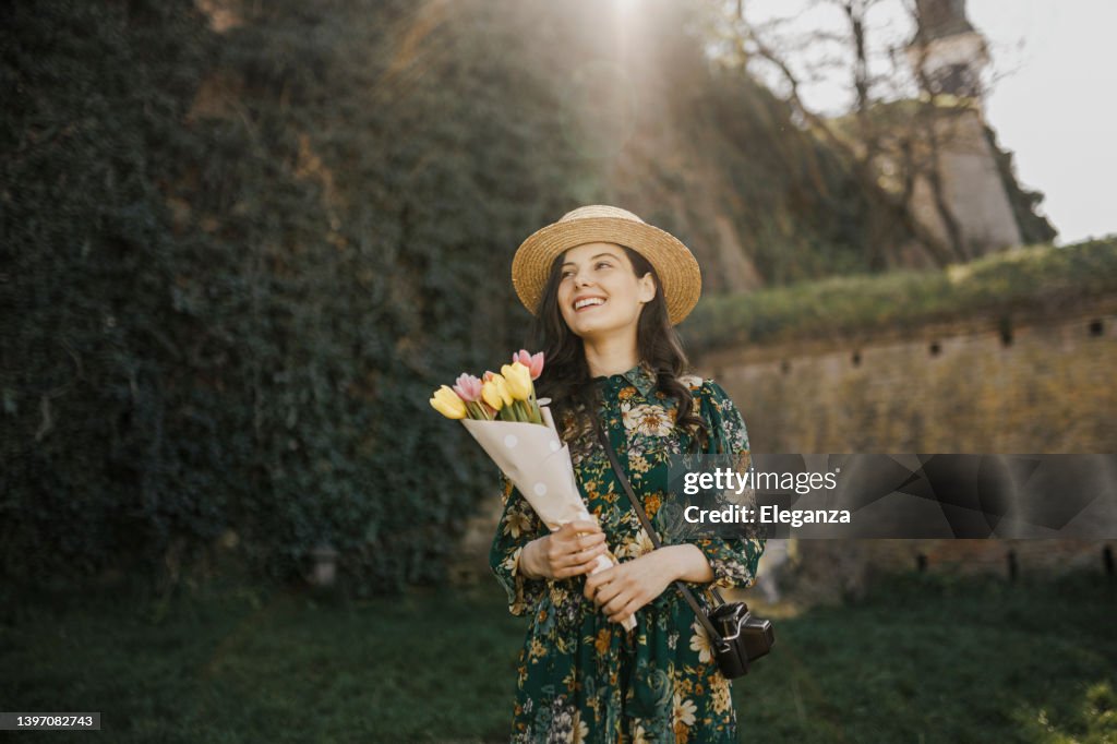 Portrait d’une jeune femme tenant un bouquet de tulipes