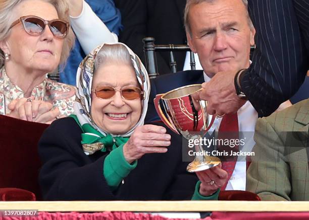 Queen Elizabeth II receives the winners cup at The Royal Windsor Horse Show at Home Park on May 13, 2022 in Windsor, England. The Royal Windsor Horse...