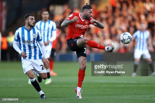 James Bree of Luton Town battles for the ball with Pipa of Huddersfield Town during the Sky Bet Championship Play-off Semi Final 1st Leg match...