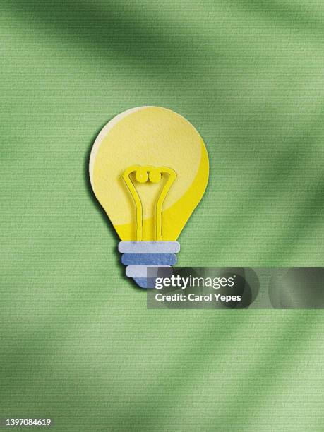 light bulb made of paper in green paper background - bombilla idea stockfoto's en -beelden