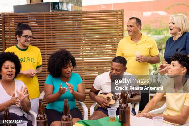 group of brazilian fans gathered to watch game - latin music stock pictures, royalty-free photos & images