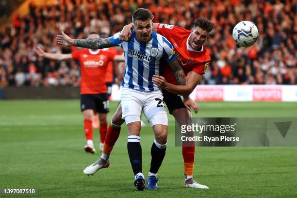Reece Burke of Luton Town battles for the ball with Danny Ward of Huddersfield Town during the Sky Bet Championship Play-off Semi Final 1st Leg match...
