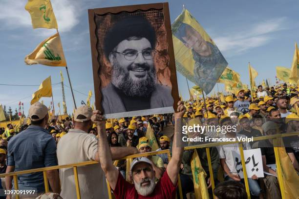 Man holding a photo of Hassan Nasrallah, Secretary-General of Hezbollah at the Hezbollah Political Party Rally on May 13, 2022 in Baalbek in Bekaa...