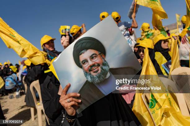 Woman holds a photo of Hassan Nasrallah, Secretary-General of Hezbollah pior the Hezbollah Political Party Rally to commemorate the anniversary of...