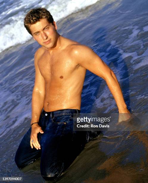 American dancer, actor, film, television producer and singer, Lance Bass, of the American boy band, NSYNC, poses for a portrait at the beach circa...