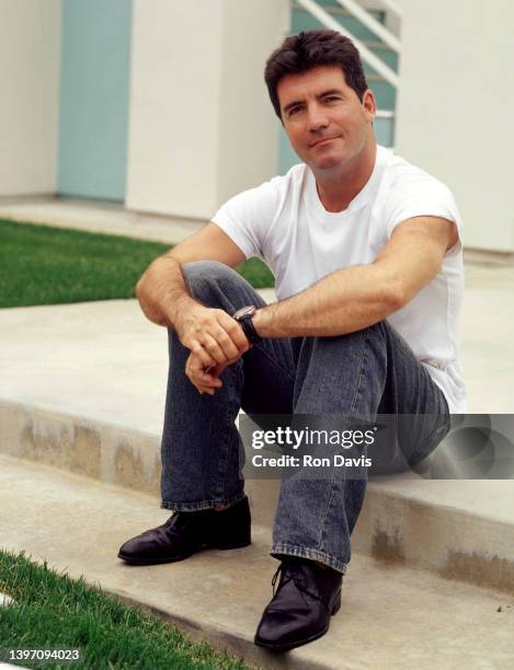 English television personality, entrepreneur, and record executive Simon Cowell, poses for a portrait circa 2002 in Los Angeles, California.