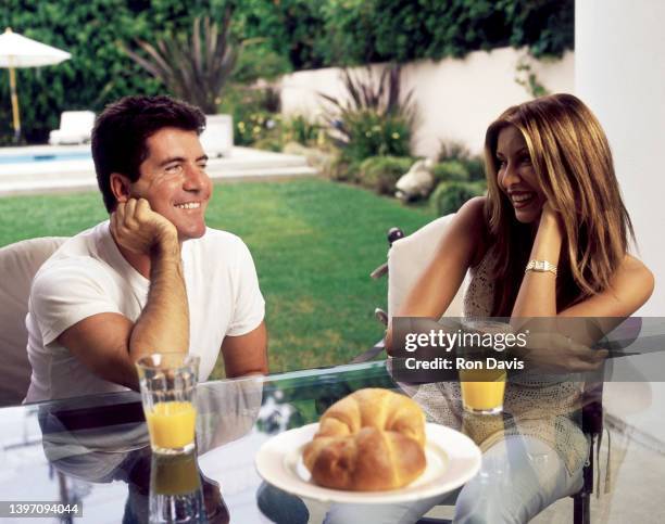 English television personality, entrepreneur, and record executive Simon Cowell and girlfriend English entertainment reporter and actress Terri...