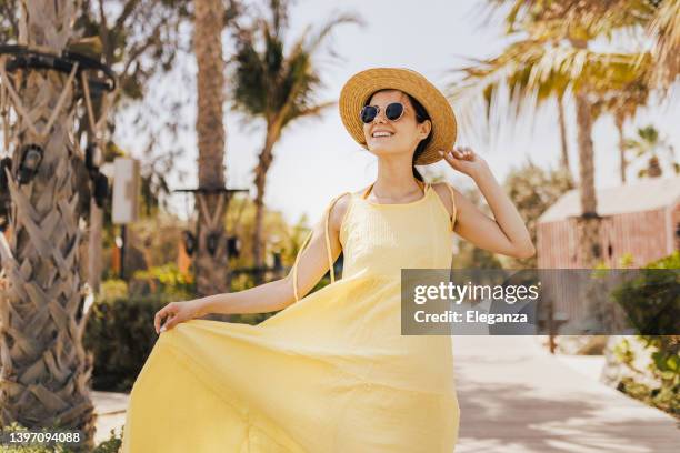 woman walking on the beach looking at the sun - summer frock stock pictures, royalty-free photos & images