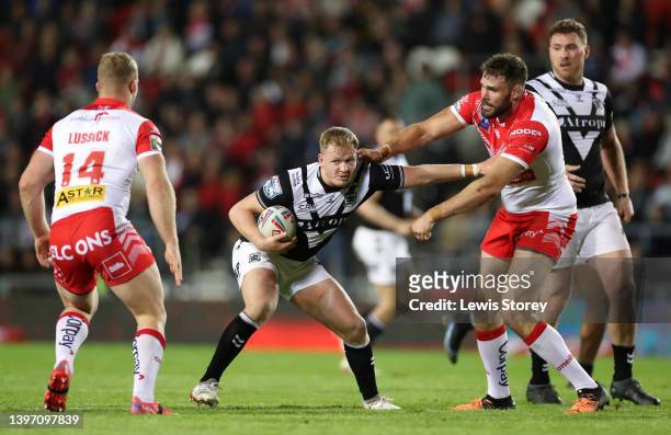 Jordan Johnstone of Hull FC is tackled by Alex Walmsley of St Helens during the Betfred Super League Round 12 match between St Helens and Hull FC at...