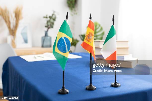 table ready for the signing of an international document with the flags of several countries. i - fresh deals ストックフォトと画像