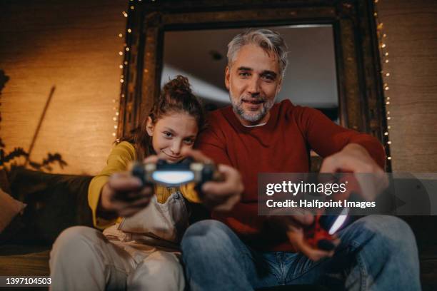 family playing video games. family bonding activities. - family game night stock pictures, royalty-free photos & images