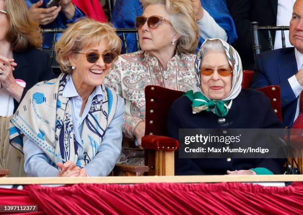 Queen Elizabeth II, accompanied by Penelope Knatchbull, Countess Mountbatten of Burma, watches her horse 'Balmoral Leia' win the 'Horse & Hound...