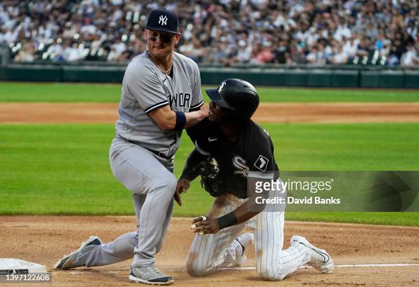 Josh Donaldson of the New York Yankees blocks third base as Tim Anderson of the Chicago White Sox tries to get back to the base at Guaranteed Rate...