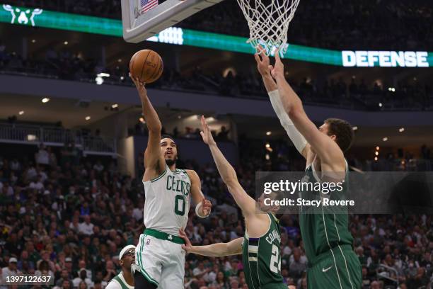 Jayson Tatum of the Boston Celtics shoots the ball against Pat Connaughton and Brook Lopez of the Milwaukee Bucks during the second quarter in Game...