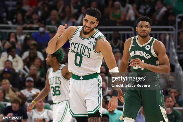 Jayson Tatum of the Boston Celtics celebrates a basket against Giannis Antetokounmpo of the Milwaukee Bucks during the third quarter in Game Six of...