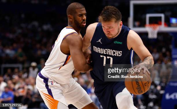 Luka Doncic of the Dallas Mavericks drives to the basket against Chris Paul of the Phoenix Suns during Game Six of the 2022 NBA Playoffs Western...
