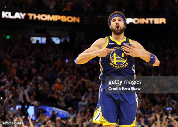 Klay Thompson of the Golden State Warriors celebrates his three-point shot against the Memphis Grizzlies in the fourth quarter in Game Six of the...