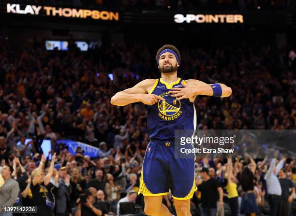 Klay Thompson of the Golden State Warriors celebrates his three-point shot against the Memphis Grizzlies in the fourth quarter in Game Six of the...