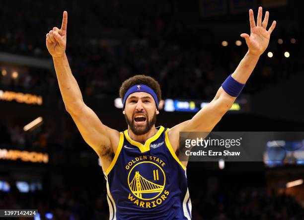 Klay Thompson of the Golden State Warriors celebrates his three-point shot against the Memphis Grizzlies in the fourth quarter in Game Six of the...