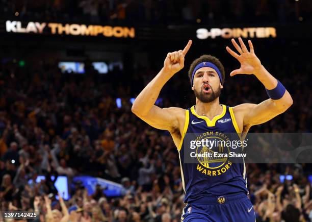 Klay Thompson of the Golden State Warriors celebrates his three-point shot against the Memphis Grizzlies in the fourth quarter in Game Six of the...