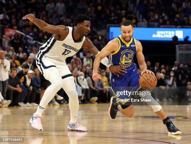 Stephen Curry of the Golden State Warriors dribbles the ball against Jaren Jackson Jr. #13 of the Memphis Grizzlies in Game Six of the 2022 NBA...