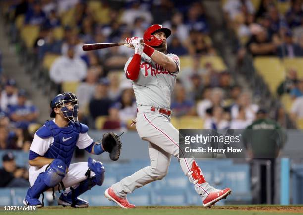 Bryce Harper of the Philadelphia Phillies watches his solo homerun with Austin Barnes of the Los Angeles Dodgers, to take a 9-7 lead over the Los...