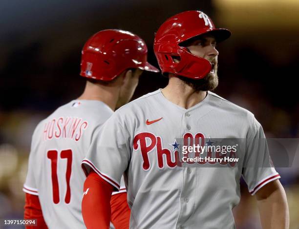 Bryce Harper of the Philadelphia Phillies celebrates his run from a two run double from Nick Castellanos, to take a 11-9 lead, during the 10th inning...